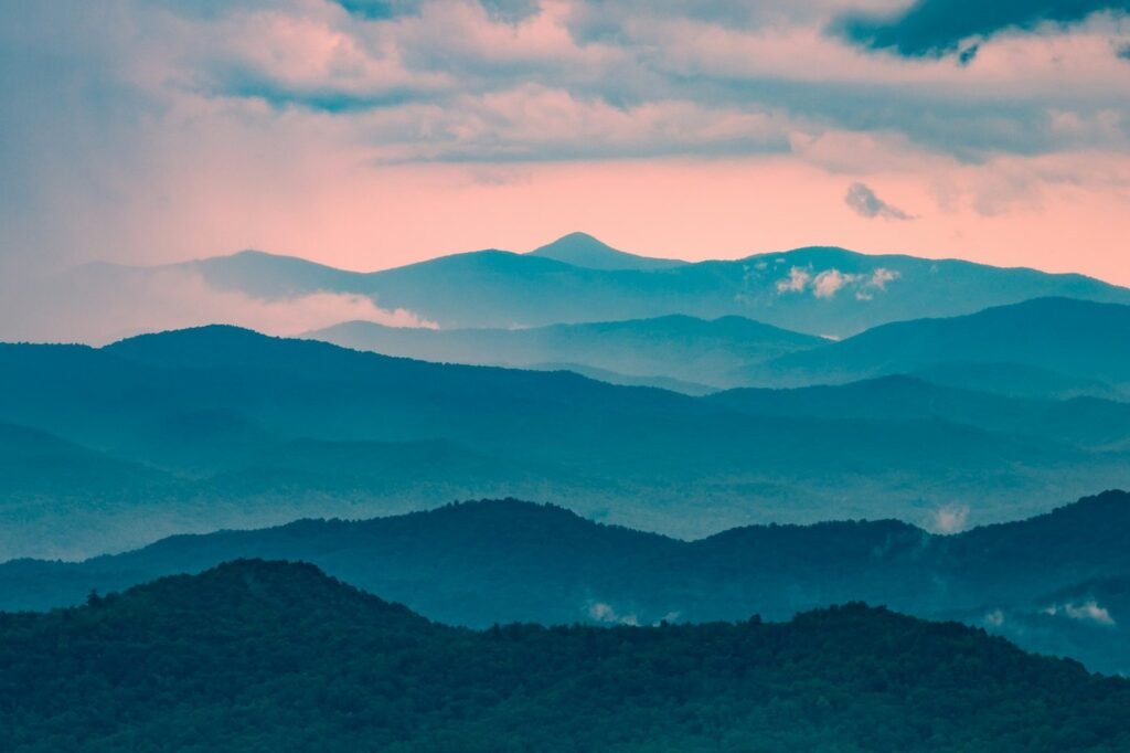 Layered blue Blue Ridge mountain ridgelines under a pink dusk sky.