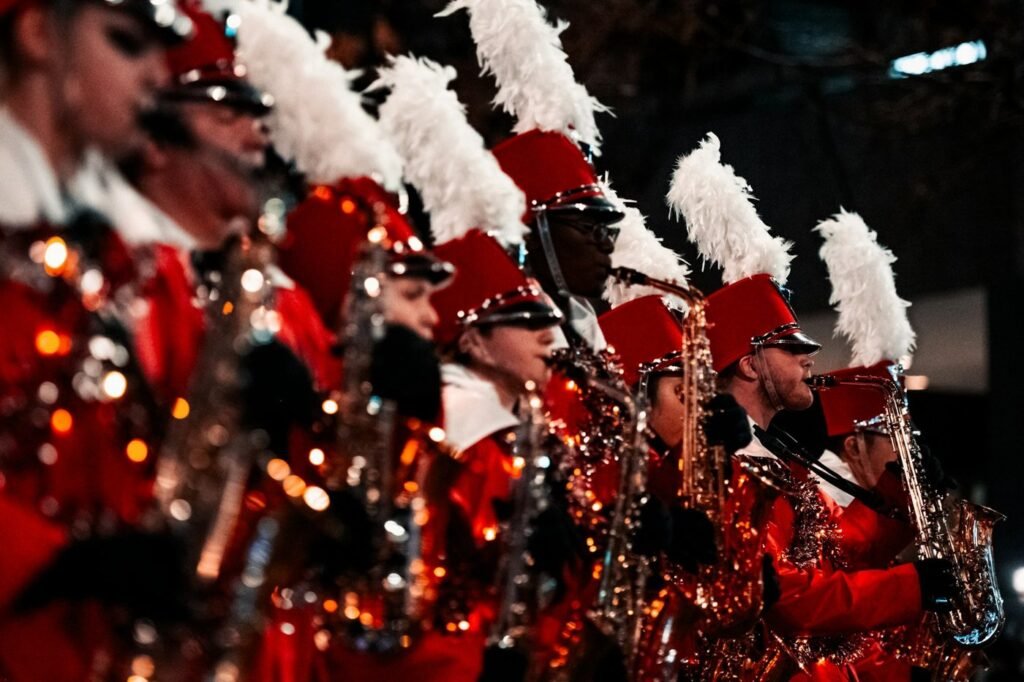 Saxophone players in red uniforms at a holiday parade; a stand-in photo