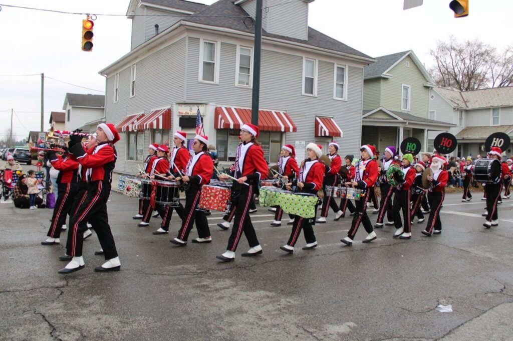 Marching band in Santa hats at a Christmas parade; a stand-in photo from another town