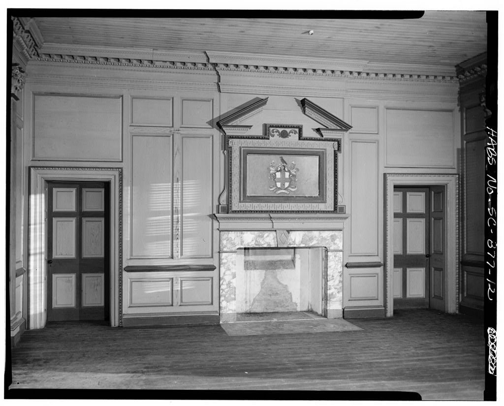 Paneled room inside Drayton Hall with a carved overmantel above a marble fireplace
